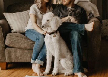 family a couple with a dog sitting on a couch